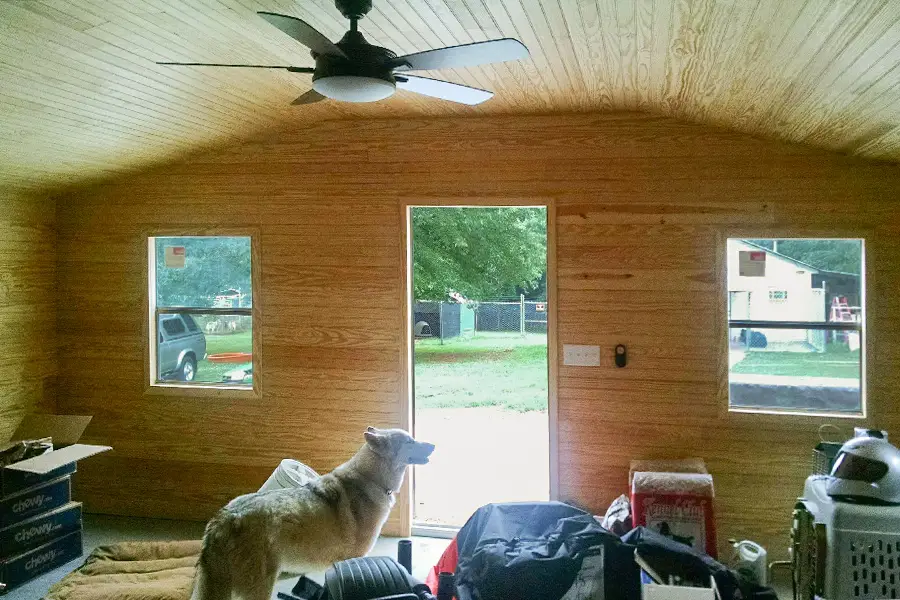 Wooden paneling on the inside of a tiny home created from a steel building garage